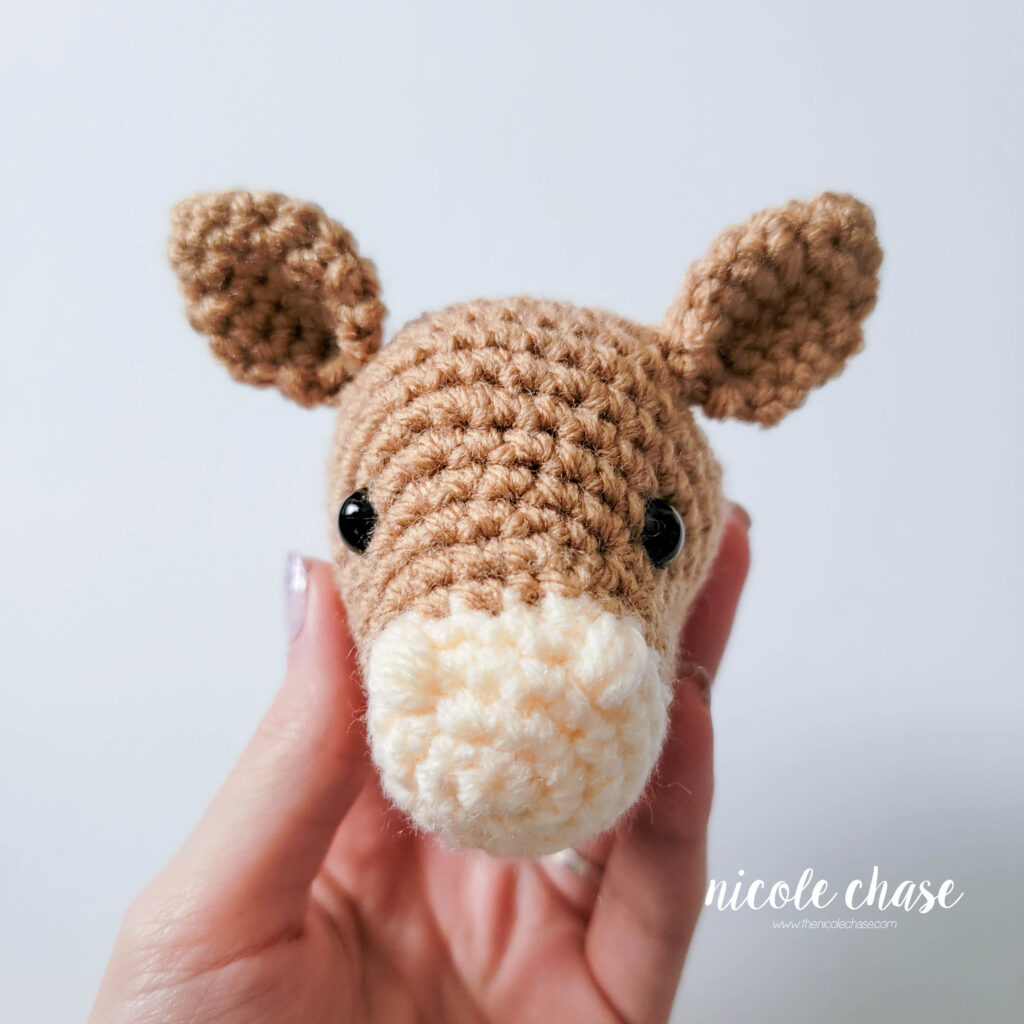 light brown crochet horse with ears sewn in place