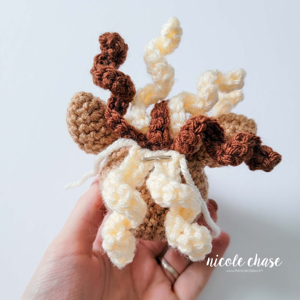 crochet horse with curl C pinned in place 